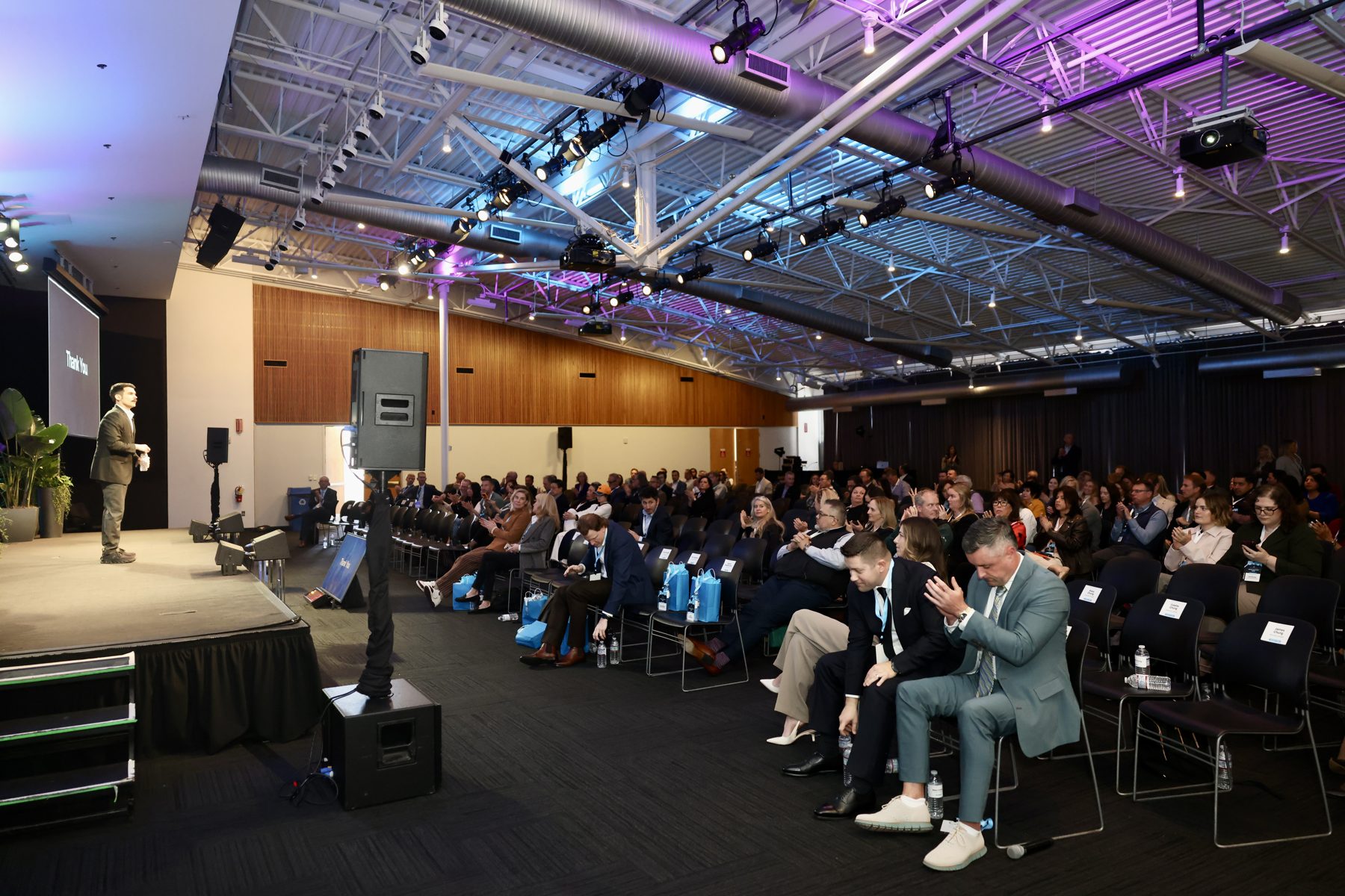 Topher Stephenson presenting to a packed audience at a commercial real estate conference