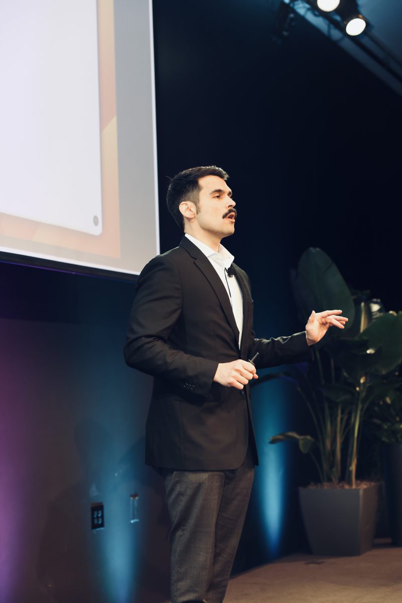 Topher Stephenson presenting on stage